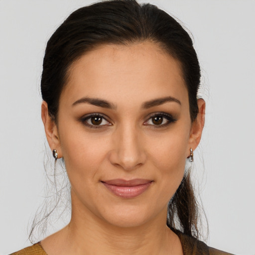 Joyful latino young-adult female with medium  brown hair and brown eyes