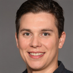 Joyful white adult male with short  brown hair and brown eyes