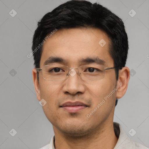 Joyful asian adult male with short  black hair and brown eyes