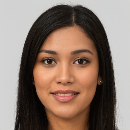 Joyful latino young-adult female with long  brown hair and brown eyes