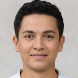 Joyful latino young-adult male with short  brown hair and brown eyes