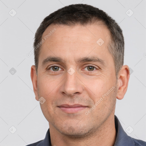 Joyful white adult male with short  brown hair and brown eyes