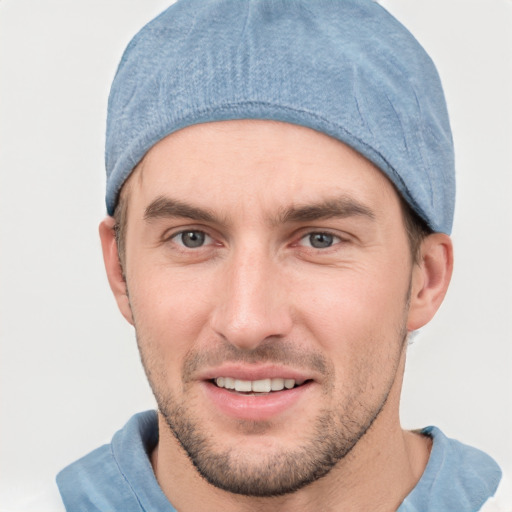 Joyful white young-adult male with short  brown hair and grey eyes