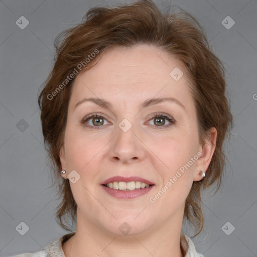 Joyful white adult female with medium  brown hair and blue eyes