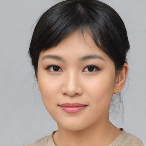 Joyful asian young-adult female with medium  black hair and brown eyes