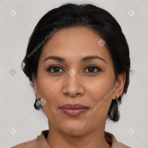 Joyful latino adult female with medium  brown hair and brown eyes