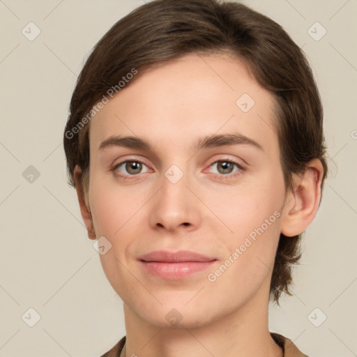 Joyful white young-adult female with short  brown hair and grey eyes