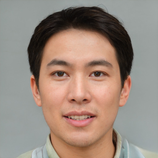 Joyful asian young-adult male with short  brown hair and brown eyes