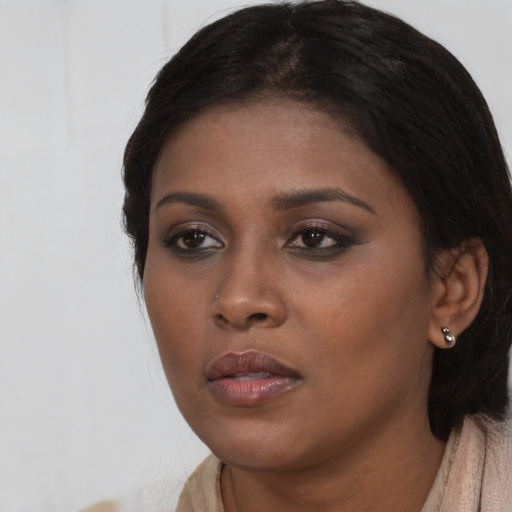 Neutral black young-adult female with long  brown hair and brown eyes