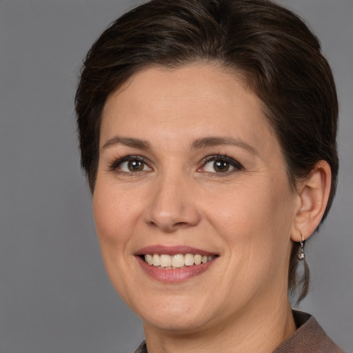 Joyful white young-adult female with medium  brown hair and brown eyes