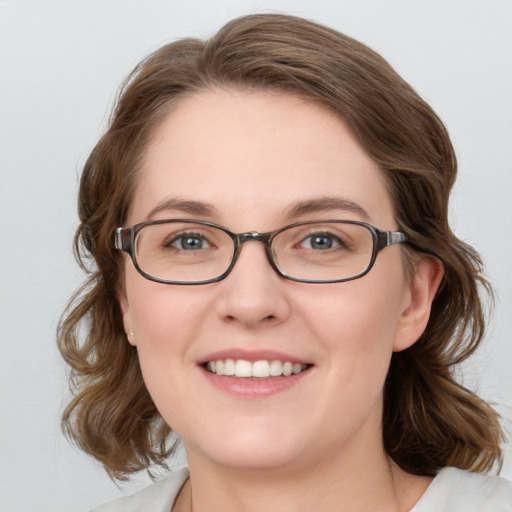 Joyful white young-adult female with medium  brown hair and blue eyes