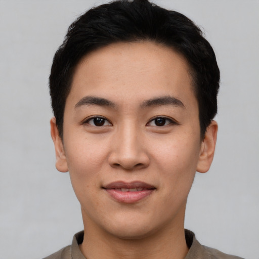 Joyful asian young-adult male with short  black hair and brown eyes