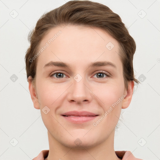 Joyful white young-adult female with short  brown hair and grey eyes