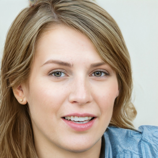 Joyful white young-adult female with long  brown hair and blue eyes