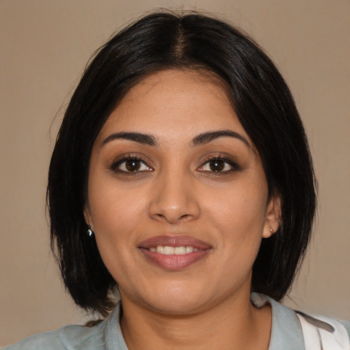 Joyful latino young-adult female with medium  black hair and brown eyes