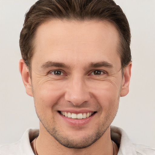 Joyful white young-adult male with short  brown hair and brown eyes