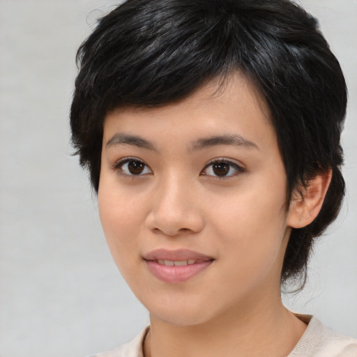 Joyful asian young-adult female with medium  black hair and brown eyes