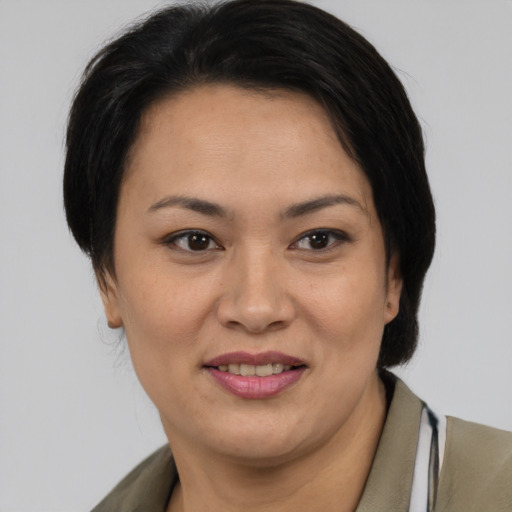 Joyful asian adult female with medium  brown hair and brown eyes