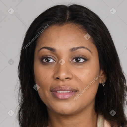 Joyful black young-adult female with long  brown hair and brown eyes