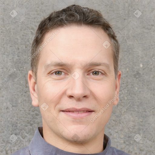 Joyful white adult male with short  brown hair and grey eyes