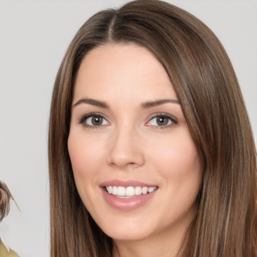 Joyful white young-adult female with long  brown hair and brown eyes