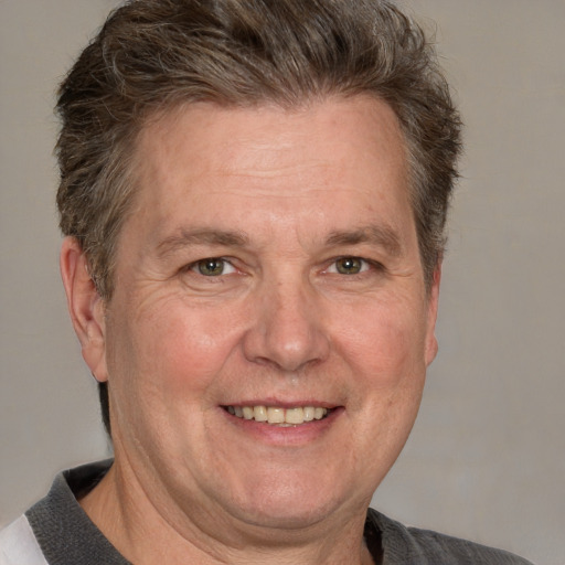 Joyful white adult male with short  brown hair and grey eyes