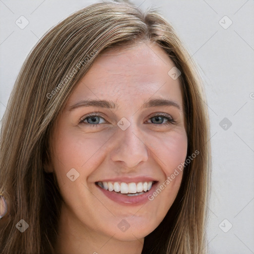 Joyful white young-adult female with long  brown hair and blue eyes