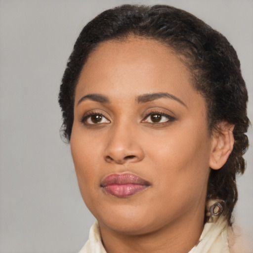 Joyful black young-adult female with medium  black hair and brown eyes