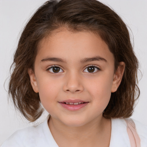 Joyful white child female with medium  brown hair and brown eyes