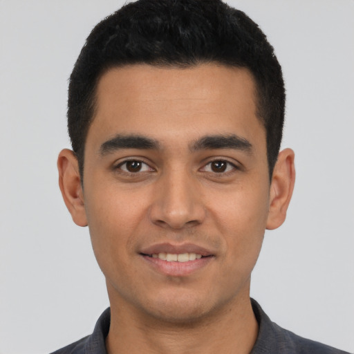 Joyful latino young-adult male with short  black hair and brown eyes