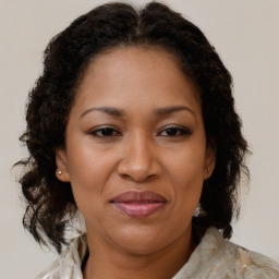 Joyful black adult female with medium  brown hair and brown eyes