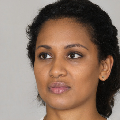 Neutral black young-adult female with medium  black hair and brown eyes