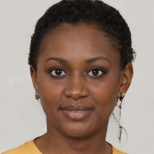 Joyful black young-adult female with short  brown hair and brown eyes
