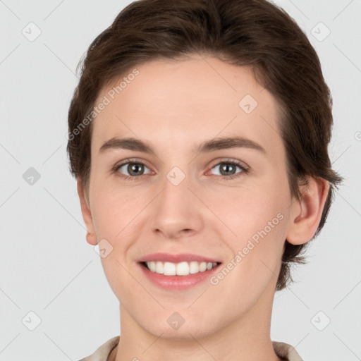 Joyful white young-adult female with short  brown hair and grey eyes