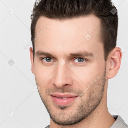 Joyful white young-adult male with short  brown hair and brown eyes