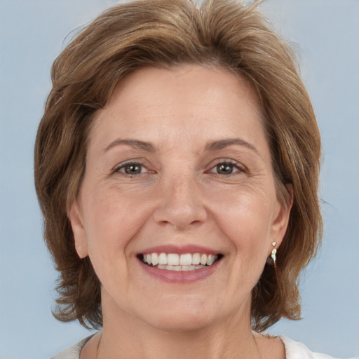 Joyful white adult female with medium  brown hair and grey eyes