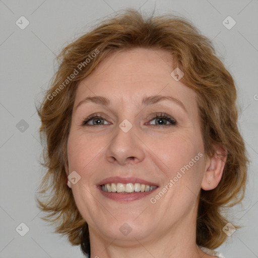 Joyful white adult female with medium  brown hair and blue eyes