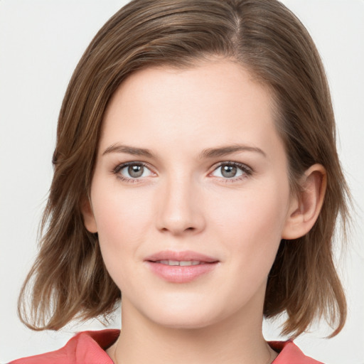 Joyful white young-adult female with medium  brown hair and blue eyes