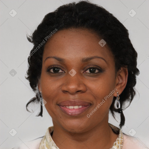 Joyful black adult female with medium  brown hair and brown eyes