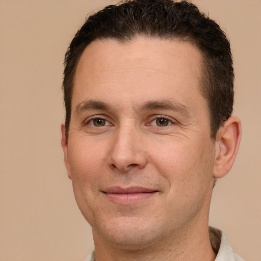 Joyful white adult male with short  brown hair and brown eyes