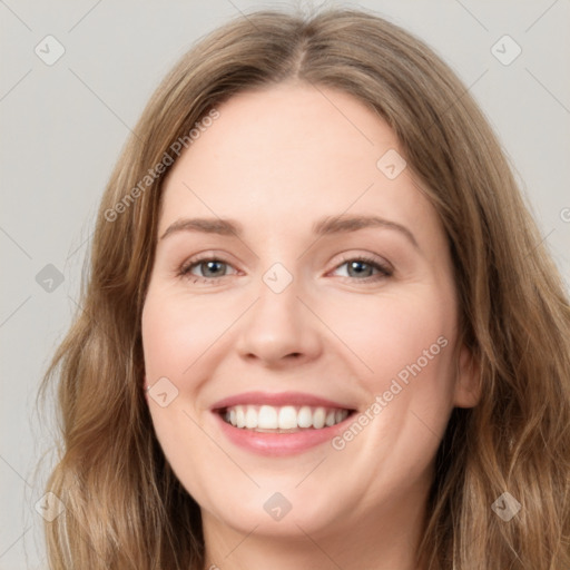 Joyful white young-adult female with long  brown hair and green eyes