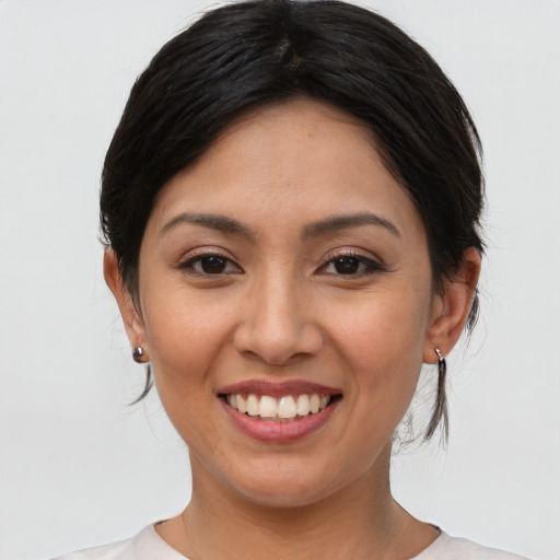 Joyful asian young-adult female with medium  brown hair and brown eyes