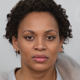 Joyful black adult female with short  brown hair and brown eyes