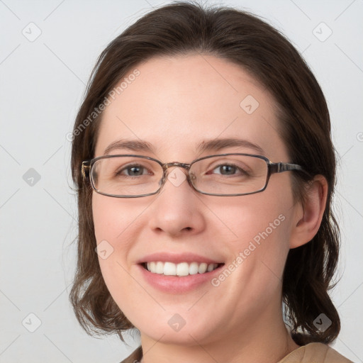 Joyful white young-adult female with medium  brown hair and grey eyes