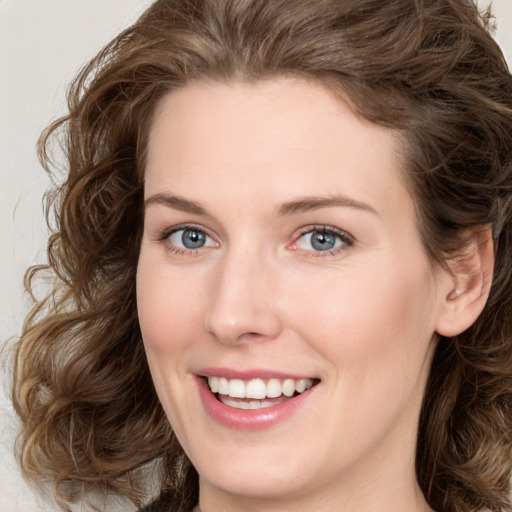 Joyful white young-adult female with medium  brown hair and green eyes