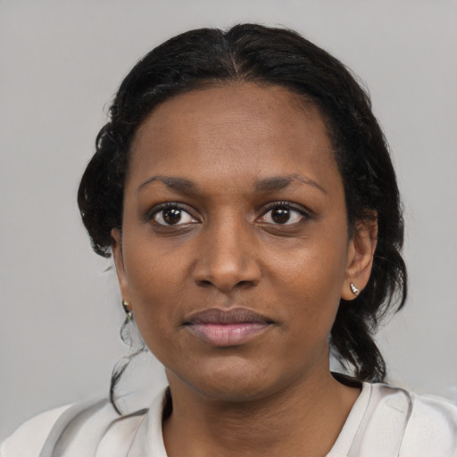 Joyful black young-adult female with medium  black hair and brown eyes