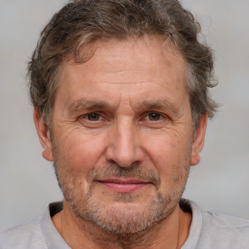 Joyful white middle-aged male with short  brown hair and brown eyes