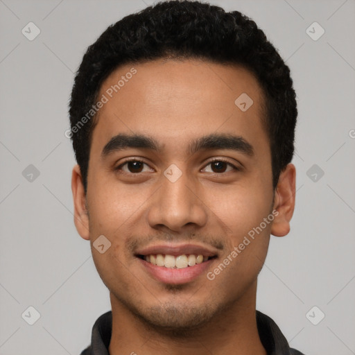 Joyful latino young-adult male with short  black hair and brown eyes