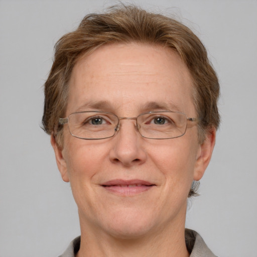 Joyful white middle-aged female with short  brown hair and grey eyes