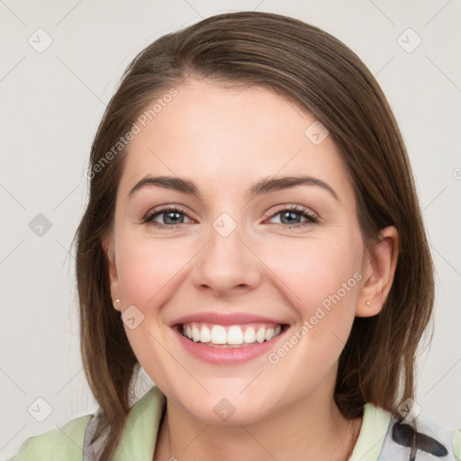 Joyful white young-adult female with medium  brown hair and grey eyes